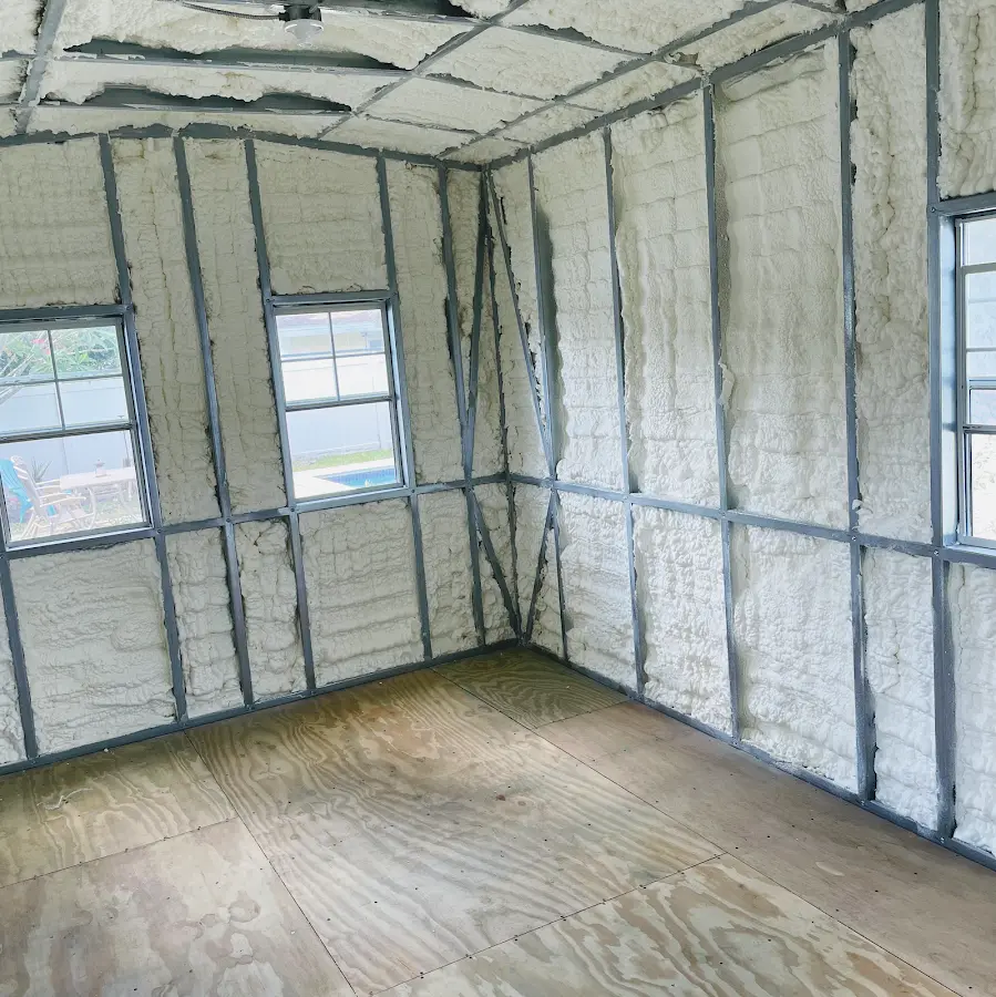 Closed-cell spray foam insulation applied to wall cavities in a residential project in Sharon